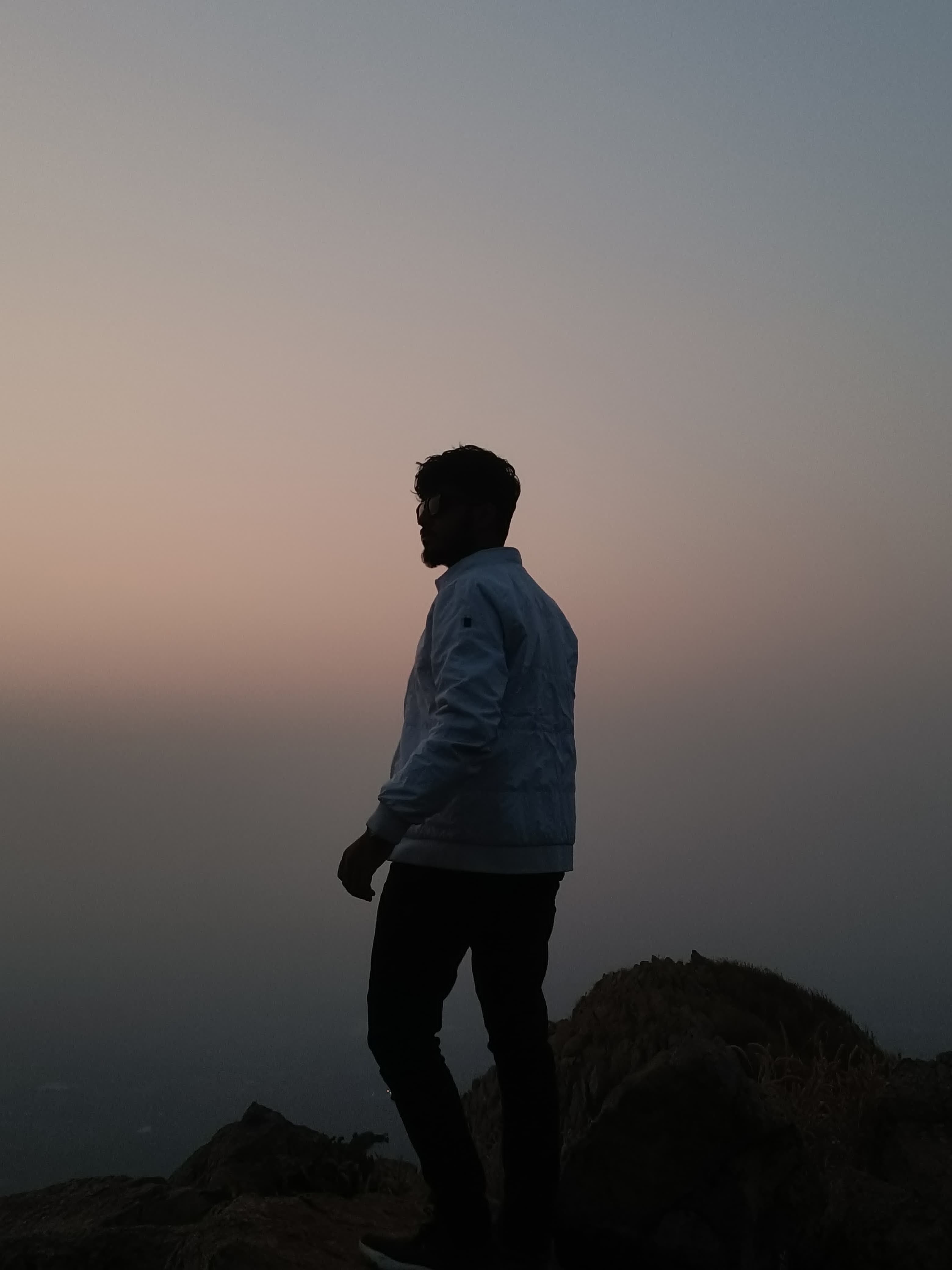 Standing on mountain top at twilight